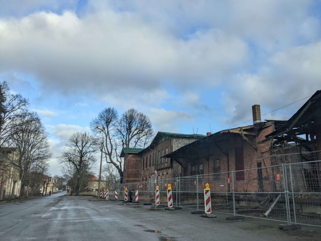 Abandoned train station cordoned off with modern metal fencing