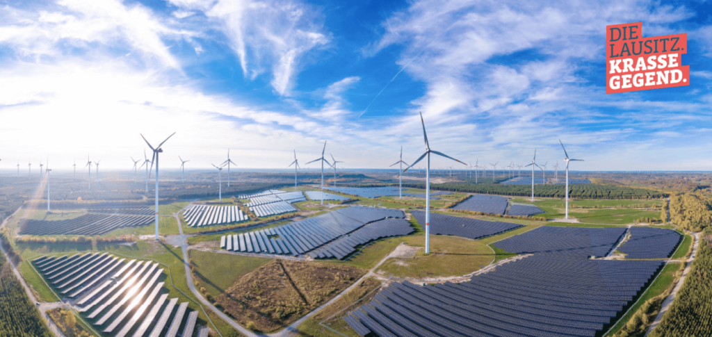 Advertisement of bright landscape with wind turbines and solar panels